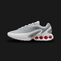 Nike Air Max Dn shoes in Pure Platinum, Wolf Grey, Metallic Silver, and University Red (Design Code: DV3337-018). Featuring a breathable Pure Platinum mesh upper with a futuristic haptic print and gleaming Metallic Silver overlays. Accented with striking University Red details and supported by the revolutionary Dynamic Air unit system, featuring dual-pressure tubes in the heel for unmatched bounce. Luxuntique offers 100% authentic Nike Air Max sneakers at the lowest price in Sri Lanka.