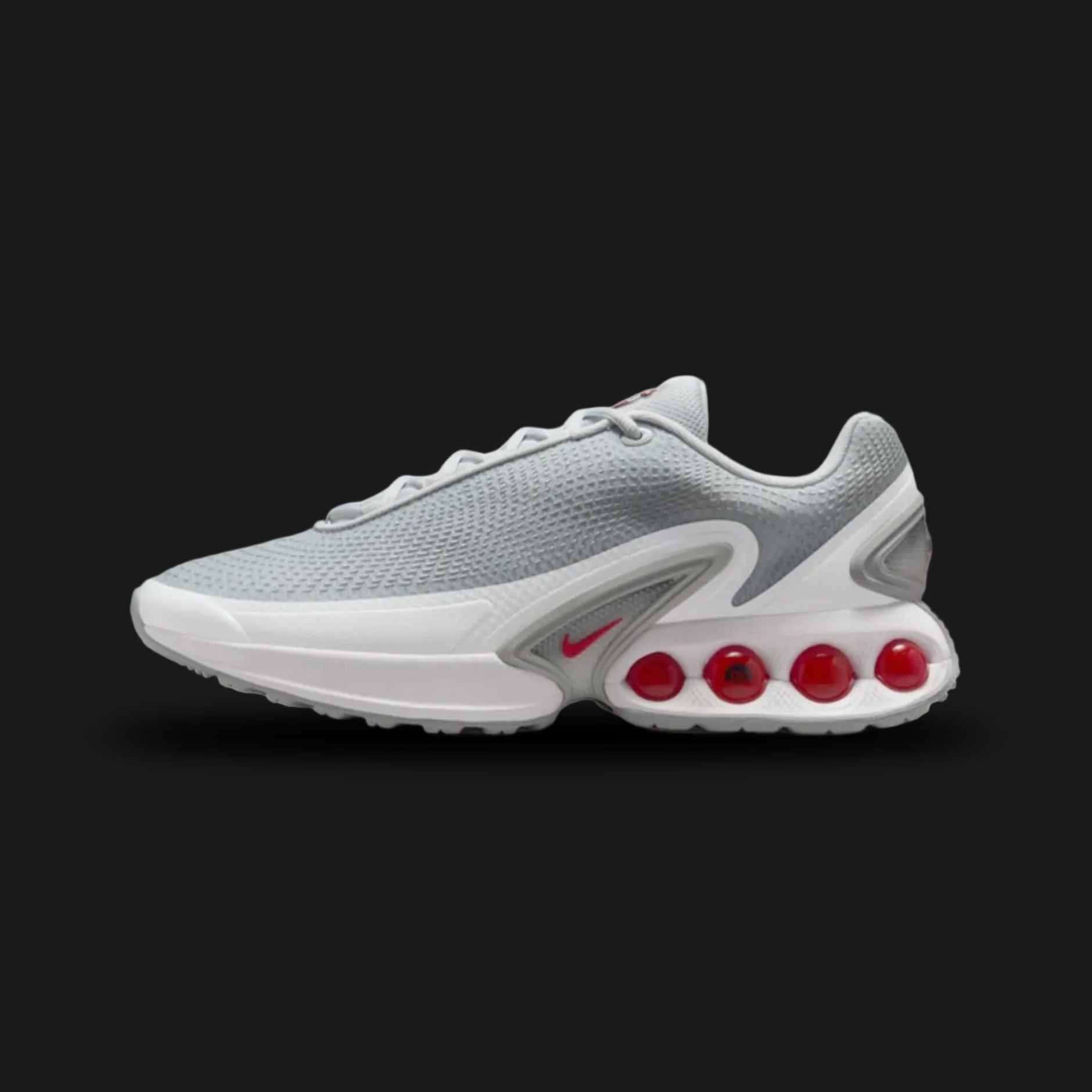 Nike Air Max Dn shoes in Pure Platinum, Wolf Grey, Metallic Silver, and University Red (Design Code: DV3337-018). Featuring a breathable Pure Platinum mesh upper with a futuristic haptic print and gleaming Metallic Silver overlays. Accented with striking University Red details and supported by the revolutionary Dynamic Air unit system, featuring dual-pressure tubes in the heel for unmatched bounce. Luxuntique offers 100% authentic Nike Air Max sneakers at the lowest price in Sri Lanka.