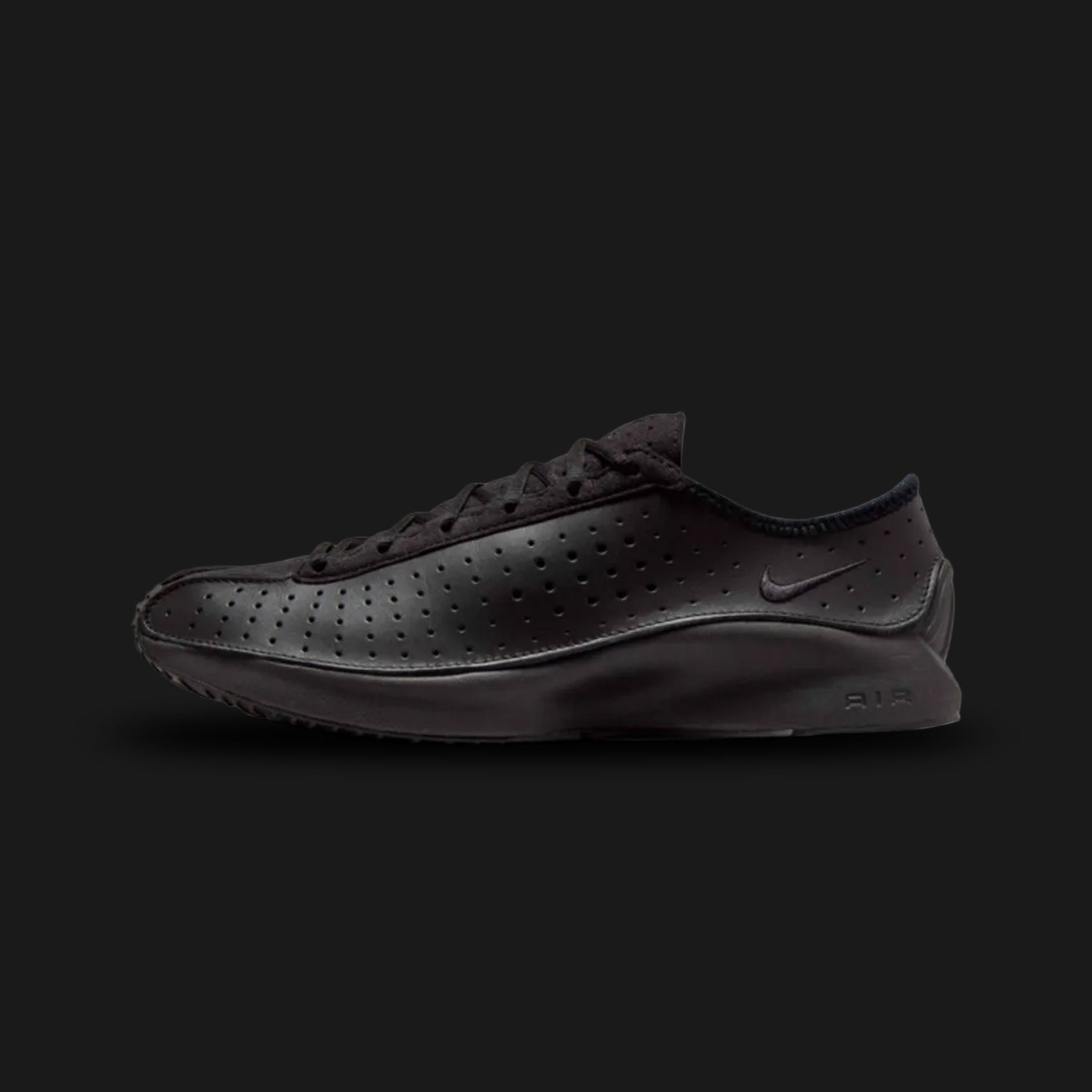 Nike Air Superfly in Black/Black/Black (HJ8082-002). Features a sleek, all-black perforated leather upper for breathability and tonal suede overlays. This low-profile archival runner includes encapsulated Air cushioning and a signature angular, aerodynamic heel design for a Y2K tech-wear aesthetic.