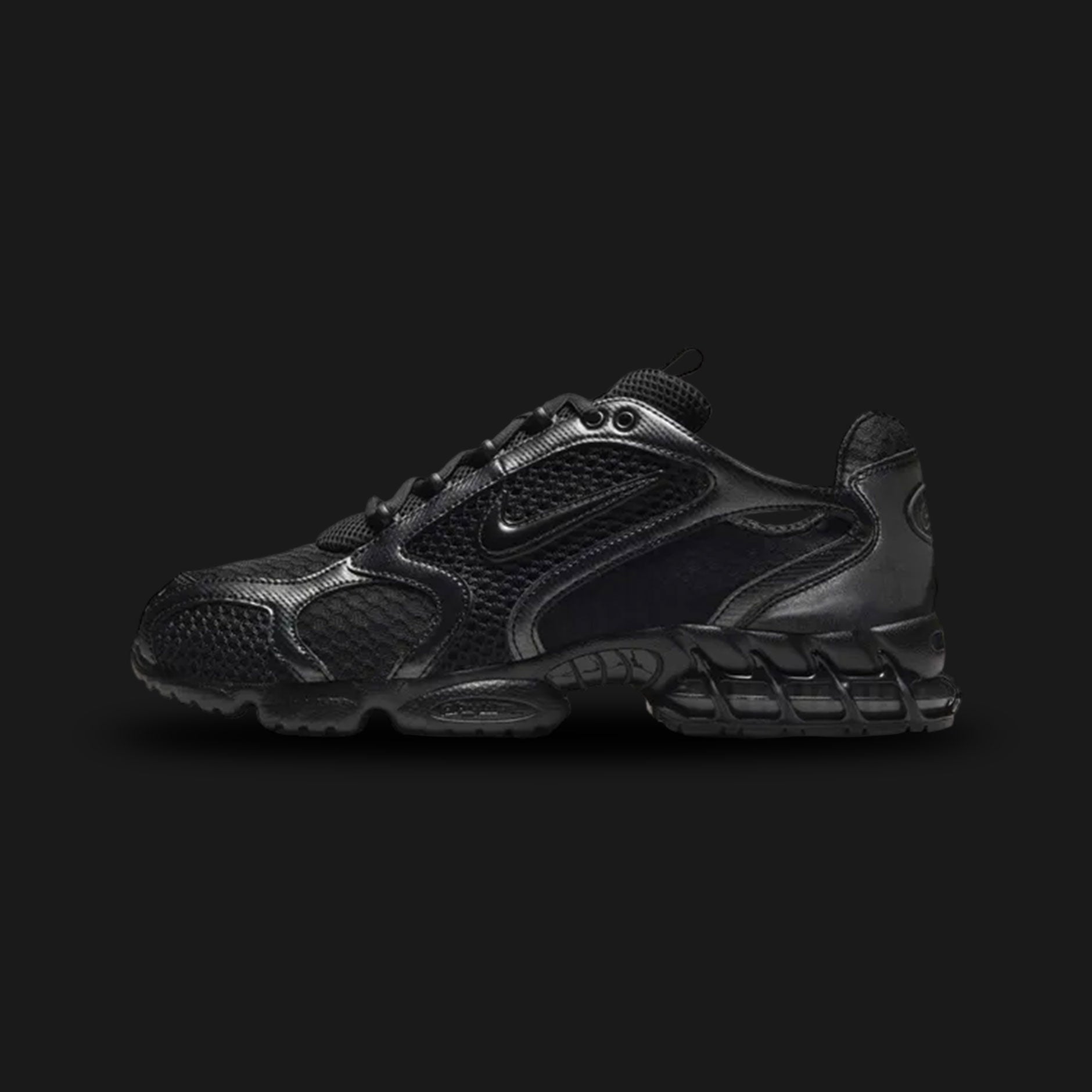 Nike Air Zoom Spiridon Cage 2 shoes in Black, Anthracite, and Smoke Grey (Design Code: HM8497-010). Featuring a breathable open-hole mesh upper encased in a glossy, supportive cage overlay for a futuristic tech aesthetic. Equipped with a visible phylite midsole and a Zoom Air unit in the heel for responsive, lightweight cushioning. Luxuntique offers 100% authentic Nike Y2K lifestyle runners at the lowest price in Sri Lanka.