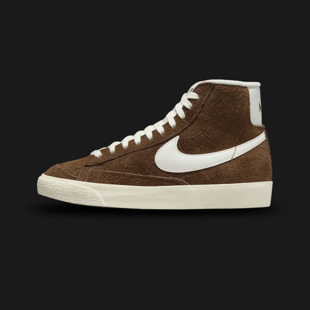 Nike Blazer Mid '77 Vintage women's shoes in Cacao Wow, Coconut Milk, and Sail (Design Code: DV7006-200). Featuring a rich Cacao Wow chocolate brown suede upper with a contrast Coconut Milk leather Swoosh and Sail vintage-treated midsole. Includes the iconic exposed foam tongue and a durable vulcanized rubber outsole. Luxuntique offers 100% authentic Nike Blazer sneakers at the lowest price in Sri Lanka.