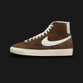 Nike Blazer Mid '77 Vintage women's shoes in Cacao Wow, Coconut Milk, and Sail (Design Code: DV7006-200). Featuring a rich Cacao Wow chocolate brown suede upper with a contrast Coconut Milk leather Swoosh and Sail vintage-treated midsole. Includes the iconic exposed foam tongue and a durable vulcanized rubber outsole. Luxuntique offers 100% authentic Nike Blazer sneakers at the lowest price in Sri Lanka.