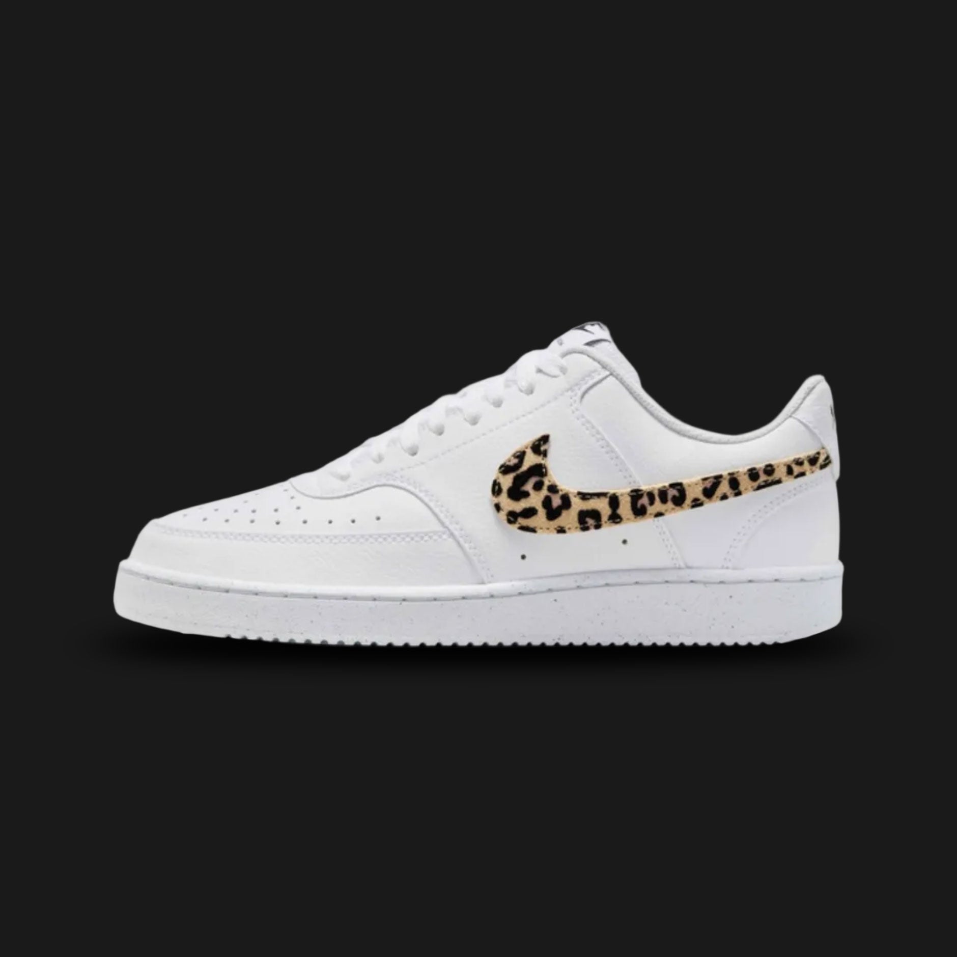 Nike Court Vision Low SE in White, Black, and Multi-Colour (IM7646-100). Features a crisp white leather base with black accents and a vibrant multi-colour graphic Swoosh. Retro 80s basketball-inspired design with a perforated toe box and a clean white cupsole. Luxuntique offers 100% authentic Nike footwear in Sri Lanka.