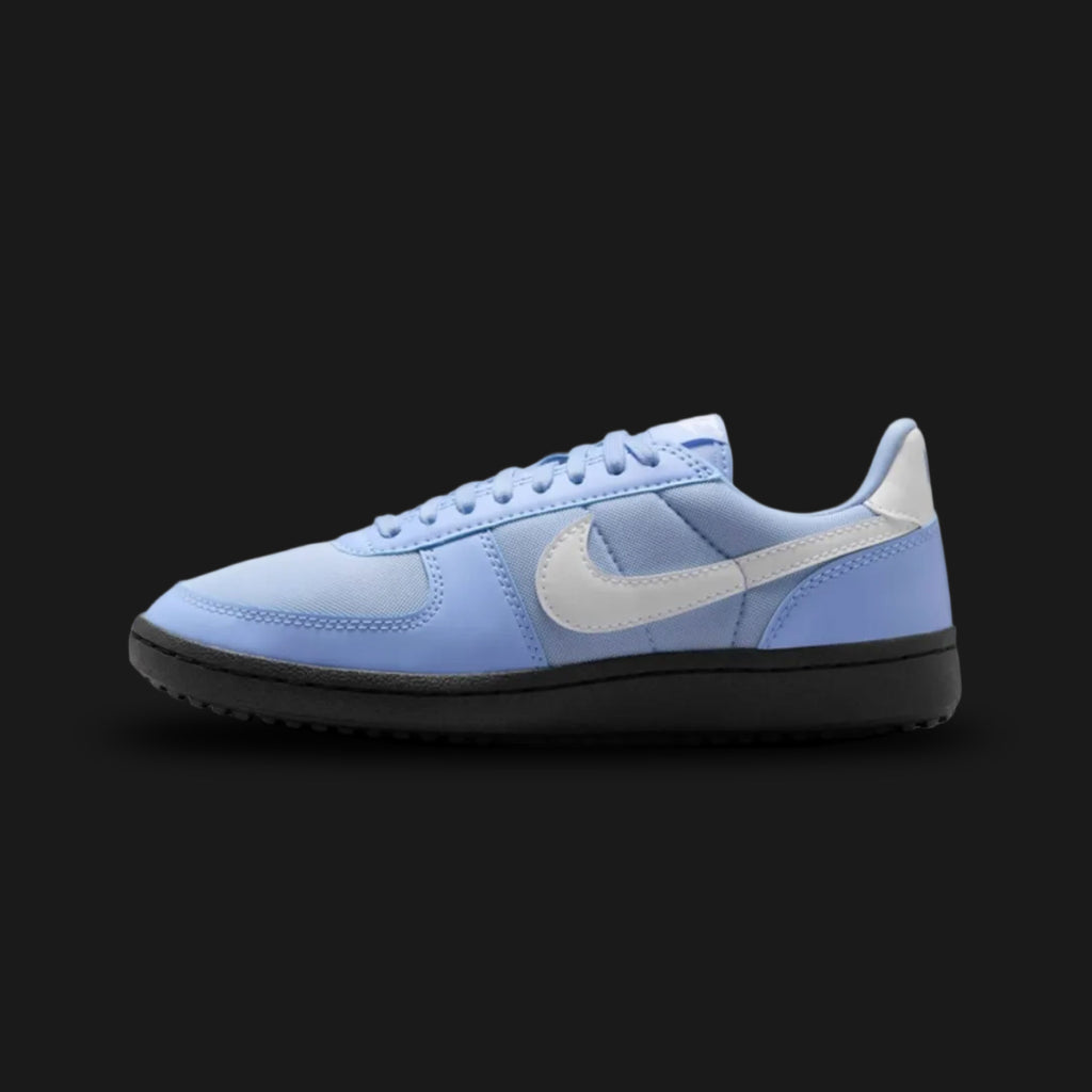 Nike Field General '82 vintage lifestyle shoes in Aluminium, Black, and White (Design Code: FZ5593-400). Featuring a breathable, icy blue Aluminium nylon upper reinforced with smooth tonal suede and leather overlays for a classic 1980s turf aesthetic. Accented by a bold, high-contrast Black leather Nike Swoosh and heel tab, along with crisp White laces. Securely built on a rugged, black rubber waffle outsole originally designed for gridiron traction. Luxuntique offers 100% authentic Nike retro footwear at t