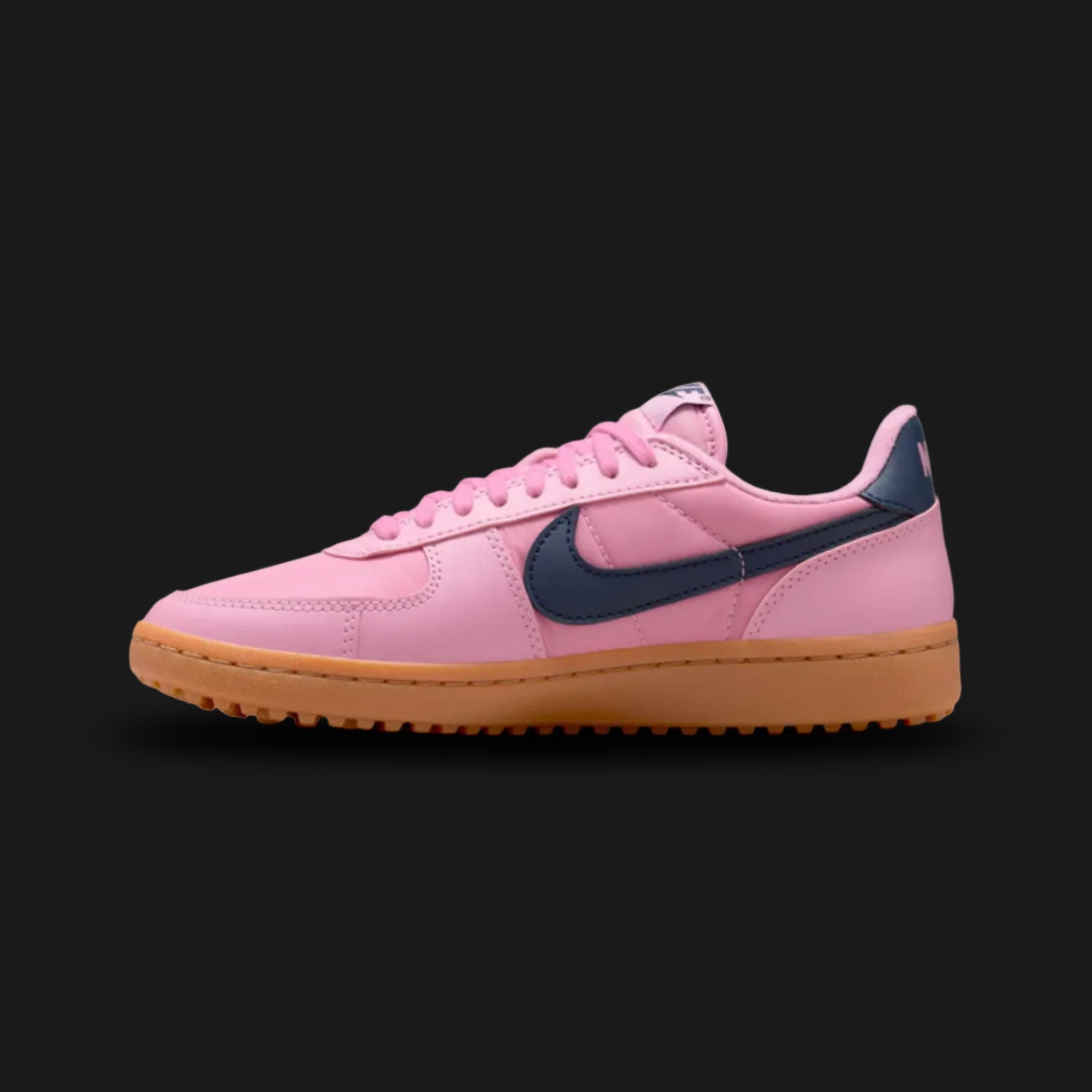 Nike Field General '82 vintage lifestyle shoes in Elemental Pink, Gum Medium Brown, and Obsidian (Design Code: FZ5593-600). Featuring a breathable, vibrant Elemental Pink nylon upper reinforced with matching tonal suede overlays for a classic 1980s turf aesthetic. Accented by a bold, high-contrast Obsidian navy blue leather Nike Swoosh and heel tab. Securely built on a rugged, Gum Medium Brown rubber waffle outsole originally designed for gridiron traction. Luxuntique offers 100% authentic Nike retro footwe