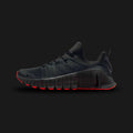 Nike Free Metcon 6 training shoes in Dark Smoke Grey, Bright Crimson, and Black (FJ7127-008). Features a highly breathable Dark Smoke Grey engineered mesh upper with durable Black overlays. Includes a wide, flat Black heel for heavy lifting stability, a grooved Nike Free forefoot for explosive agility, and vibrant Bright Crimson accents. Luxuntique offers 100% authentic Nike in Sri Lanka.