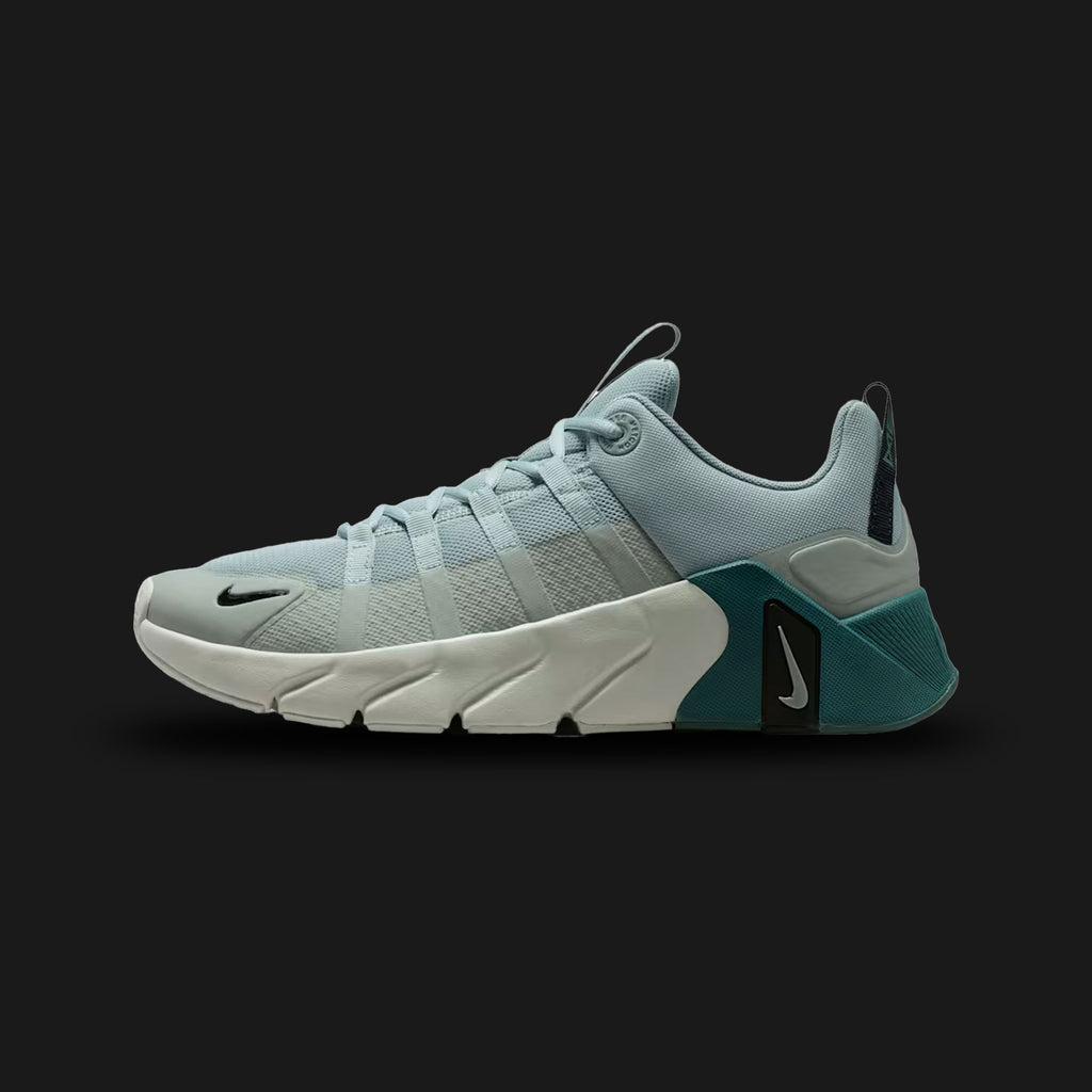 Nike Free Metcon 7 training shoes in Light Pumice, Mineral Slate, Black, and Light Silver (II7405-003). Features a breathable Light Pumice chain-link mesh upper with muted Mineral Slate overlays. Includes a wide, stable Black heel for heavy lifting and a grooved Nike Free forefoot for explosive agility. Luxuntique offers 100% authentic Nike in Sri Lanka.