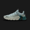 Nike Free Metcon 7 training shoes in Light Pumice, Mineral Slate, Black, and Light Silver (II7405-003). Features a breathable Light Pumice chain-link mesh upper with muted Mineral Slate overlays. Includes a wide, stable Black heel for heavy lifting and a grooved Nike Free forefoot for explosive agility. Luxuntique offers 100% authentic Nike in Sri Lanka.