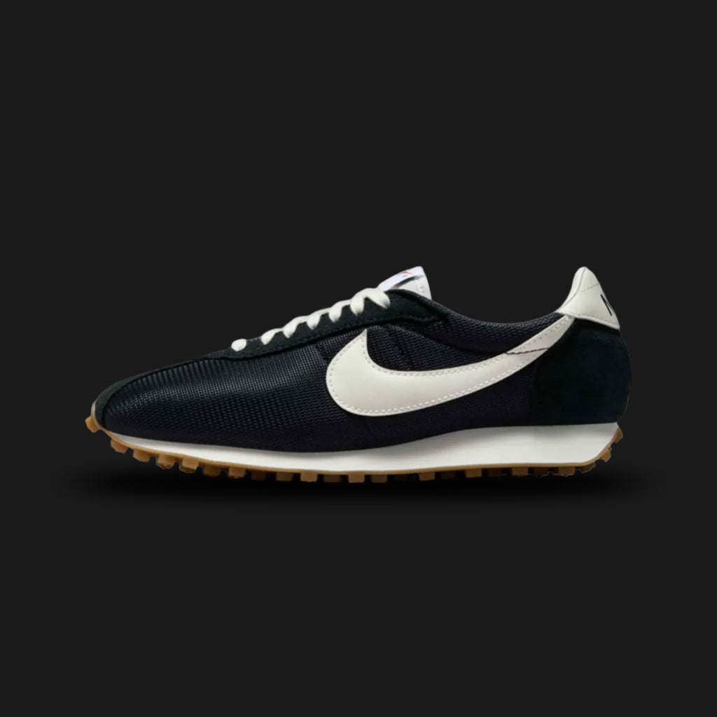 Nike LD-1000 retro running shoes in Black, Safety Orange, Gum Light Brown, and Sail (Design Code: HF3227-001). Featuring a classic, vintage-inspired black mesh upper reinforced with durable black suede and leather overlays. Accented by a striking Safety Orange Nike Swoosh and heel tab. Anchored by a retro Sail foam midsole with a signature flared heel, all finished with a heavy-duty Gum Light Brown Waffle rubber outsole. Luxuntique offers 100% authentic Nike retro footwear at the lowest price in Sri Lanka.