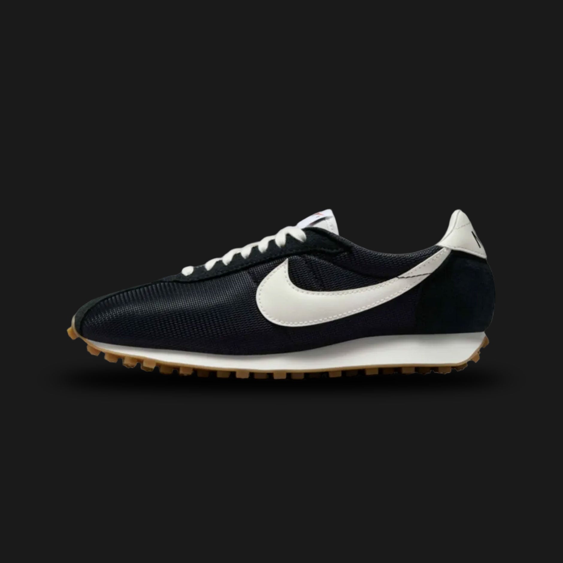 Nike LD-1000 retro running shoes in Black, Safety Orange, Gum Light Brown, and Sail (Design Code: HF3227-001). Featuring a classic, vintage-inspired black mesh upper reinforced with durable black suede and leather overlays. Accented by a striking Safety Orange Nike Swoosh and heel tab. Anchored by a retro Sail foam midsole with a signature flared heel, all finished with a heavy-duty Gum Light Brown Waffle rubber outsole. Luxuntique offers 100% authentic Nike retro footwear at the lowest price in Sri Lanka.