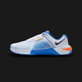 Nike Metcon 10 training shoes in Football Grey, Blue Crystal, Orange Frost, and Midnight Navy (HJ1875-008). Features an enlarged Hyperlift plate in the heel for stability and an extended rubber rope wrap for high-intensity durability. Breathable haptic-print mesh upper with a dual-density midsole for lifting and movement. Luxuntique offers 100% authentic Nike in Sri Lanka.