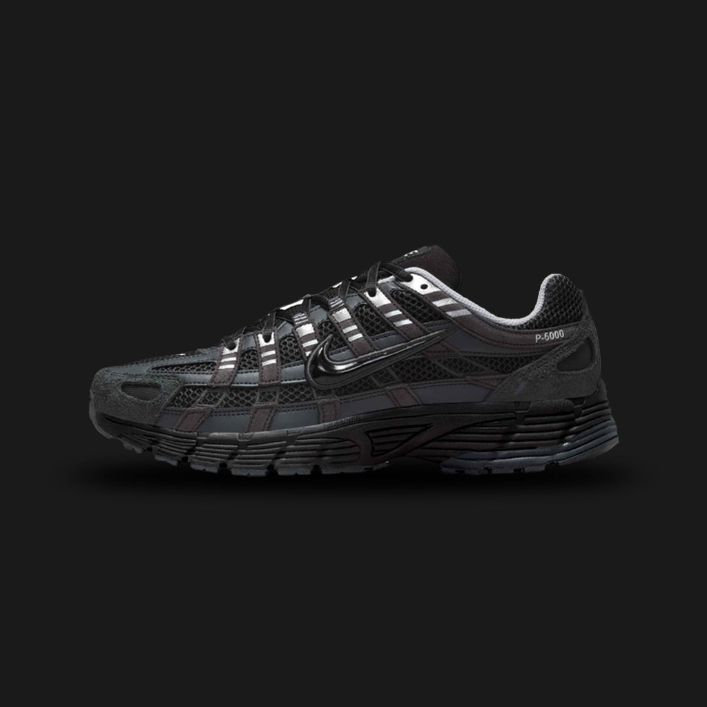 Nike P-6000 Suede shoes in Anthracite, Chrome, Metallic Silver, and Black (HF0015-002). Features a breathable mesh base with premium suede and metallic leather overlays, cushioned foam midsole, and a durable rubber outsole. Luxuntique guarantees 100% authentic footwear.