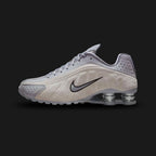 Nike Shox R4 sneakers in Cement Grey, College Grey, and Metallic Silver (HQ7739-001). Sleek synthetic leather upper featuring Metallic Silver hits and signature four-pillar Shox heel cushioning in Black. Luxuntique offers 100% authentic Nike footwear in Sri Lanka.