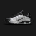 Nike Shox R4 shoes in Metallic Silver and Black (Design Code: HQ1988-007). Featuring a futuristic, seamless synthetic upper in gleaming Metallic Silver with breathable perforations and bold black detailing. Supported by the iconic 4-column Nike Shox cushioning system in the heel for responsive impact protection and a distinct Y2K aesthetic. Luxuntique offers 100% authentic Nike Shox sneakers at the lowest price in Sri Lanka.