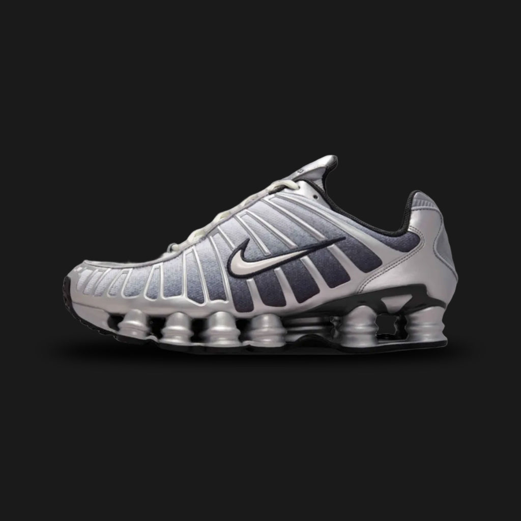 Nike Shox TL retro running shoes in Metallic Silver, Wolf Grey, Anthracite, and Summit White (Design Code: IH4466-095). Featuring a breathable Wolf Grey mesh upper tightly encased in a gleaming Metallic Silver TPU exoskeleton cage for dynamic support. Built on the iconic, full-length mechanical Nike Shox pillar cushioning system in stealthy Anthracite, delivering aggressive Y2K aesthetics and superior impact protection. Luxuntique offers 100% authentic Nike lifestyle sneakers at the lowest price in Sri Lank