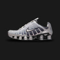 Nike Shox TL retro running shoes in Metallic Silver, Wolf Grey, Anthracite, and Summit White (Design Code: IH4466-095). Featuring a breathable Wolf Grey mesh upper tightly encased in a gleaming Metallic Silver TPU exoskeleton cage for dynamic support. Built on the iconic, full-length mechanical Nike Shox pillar cushioning system in stealthy Anthracite, delivering aggressive Y2K aesthetics and superior impact protection. Luxuntique offers 100% authentic Nike lifestyle sneakers at the lowest price in Sri Lank