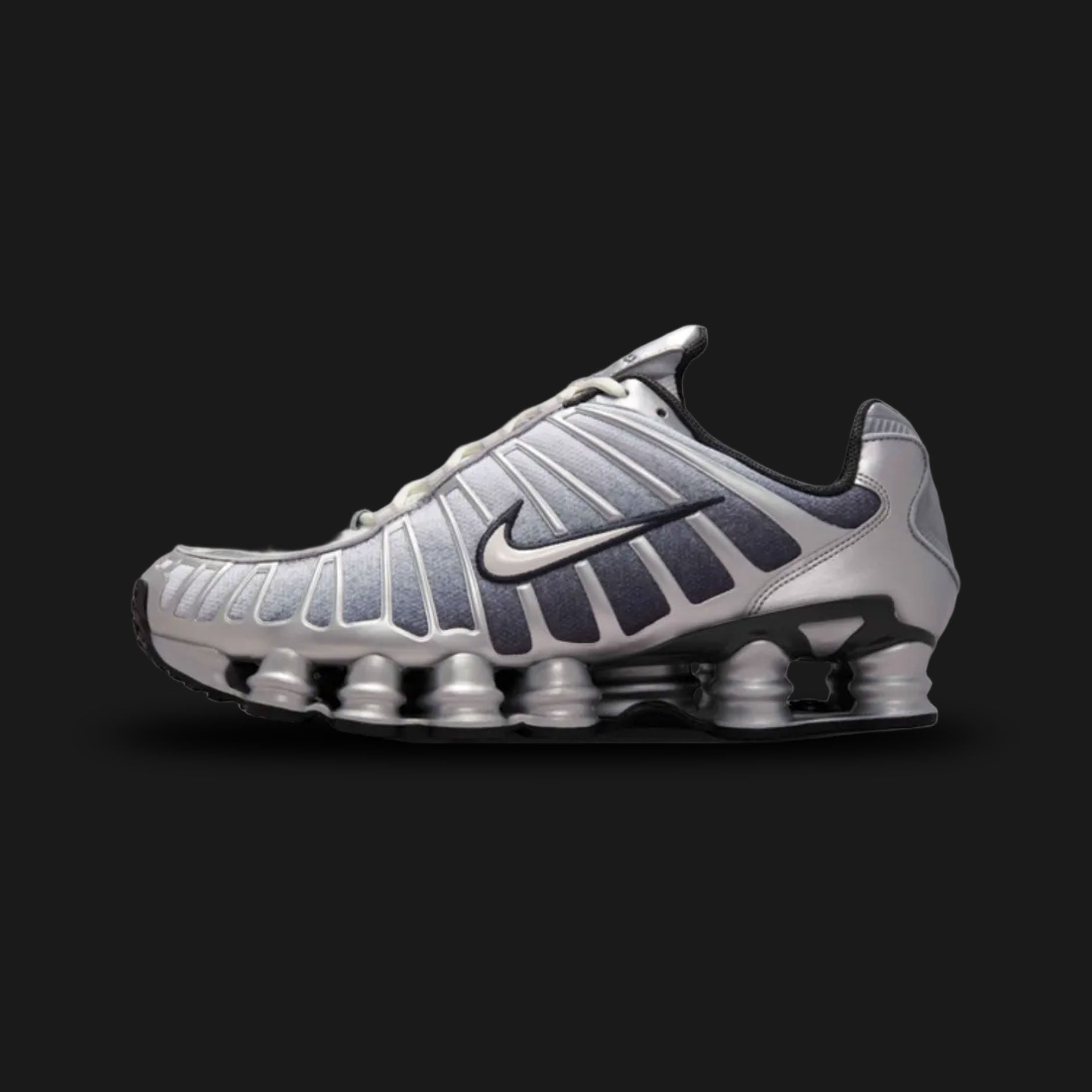 Nike Shox TL retro running shoes in Metallic Silver, Wolf Grey, Anthracite, and Summit White (Design Code: IH4466-095). Featuring a breathable Wolf Grey mesh upper tightly encased in a gleaming Metallic Silver TPU exoskeleton cage for dynamic support. Built on the iconic, full-length mechanical Nike Shox pillar cushioning system in stealthy Anthracite, delivering aggressive Y2K aesthetics and superior impact protection. Luxuntique offers 100% authentic Nike lifestyle sneakers at the lowest price in Sri Lank