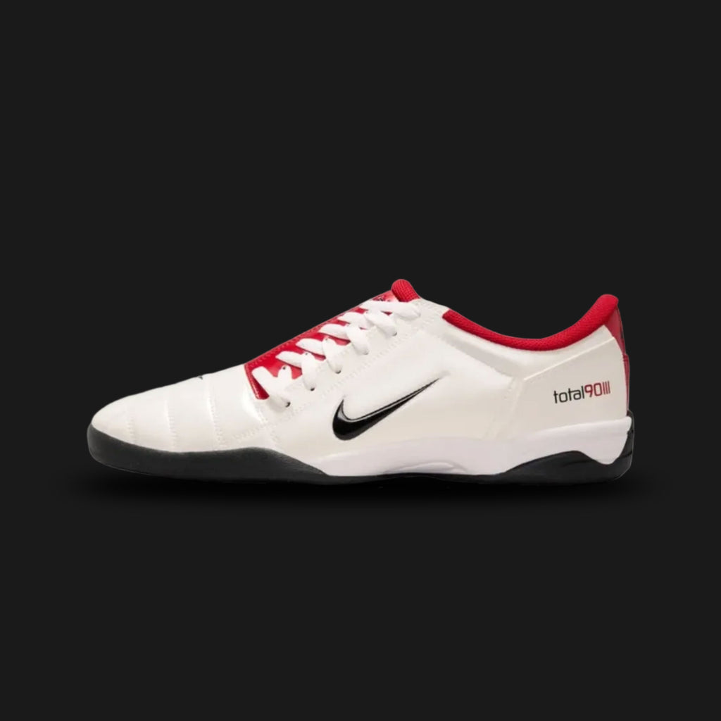 Nike Total 90 lifestyle and street shoes in White, Gym Red, and Black (Design Code: HQ2851-100). Featuring a crisp White synthetic upper defined by the iconic asymmetrical off-center lacing system and signature 3D textured striking zones. Accented with aggressive Black detailing and bold Gym Red highlights, built on a durable rubber outsole for exceptional street-ready traction. Luxuntique offers 100% authentic Nike retro footwear at the lowest price in Sri Lanka.