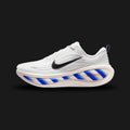 Nike Vomero Plus shoes in White, Racer Blue, Bright Crimson, and Black (II5257-100). Features a heavily layered breathable white mesh upper with synthetic overlays and a structural midfoot cage. Includes a plush Cushlon foam midsole with Zoom Air cushioning, accented by bold Racer Blue and Bright Crimson details. Luxuntique offers 100% authentic Nike in Sri Lanka.