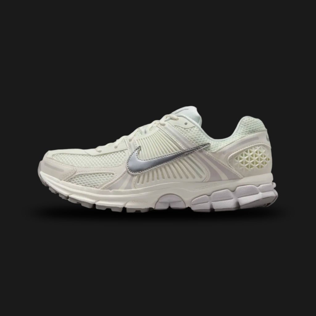 Nike Zoom Vomero 5 retro running shoes in Sail, Vast Grey, College Grey, and Metallic Silver (Design Code: FB9149-103). Featuring a richly layered Sail and Vast Grey upper combining breathable mesh, synthetic suede, and leather overlays. Accented with signature plastic side caging, reflective Metallic Silver detailing, and supported by a Cushlon foam midsole with responsive Zoom Air cushioning. Luxuntique offers 100% authentic Nike lifestyle sneakers at the lowest price in Sri Lanka.