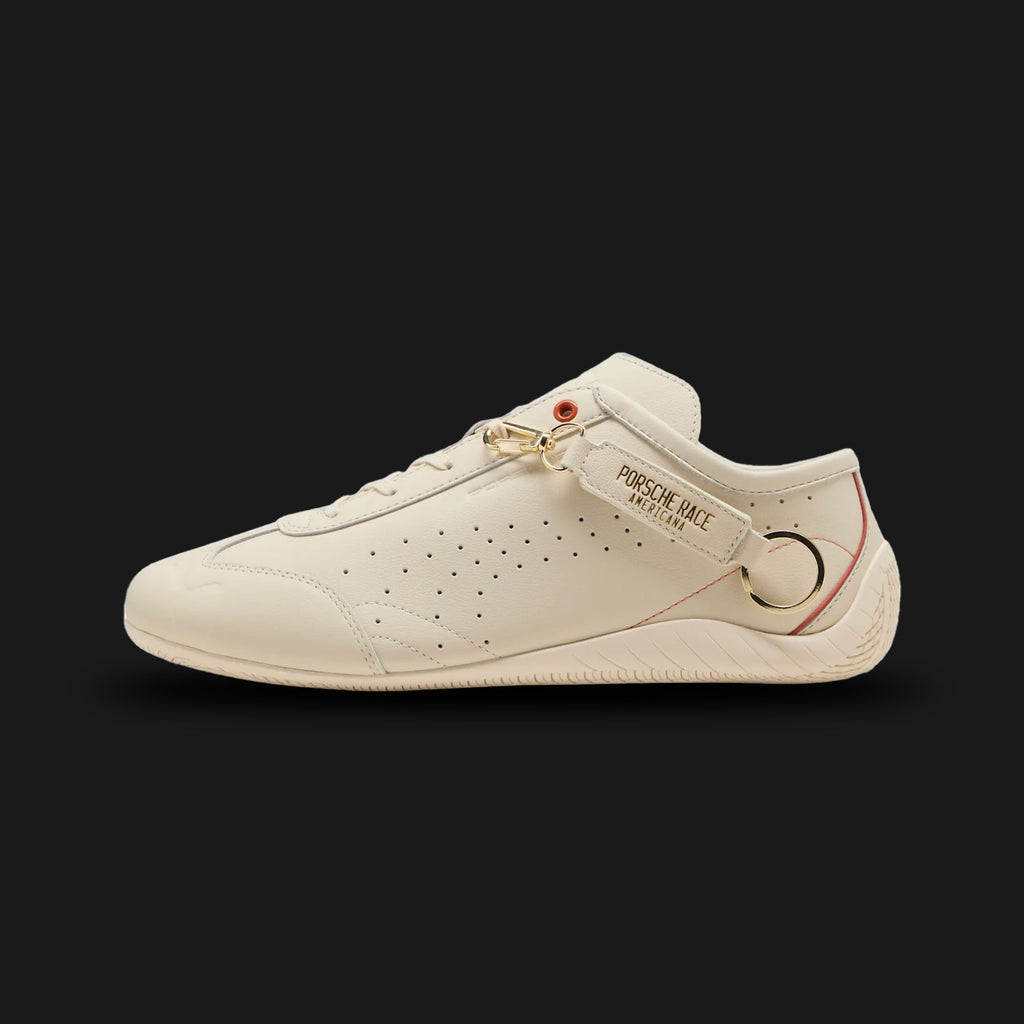Porsche Legacy Speedcat unisex sneakers in Alpine Snow and Amarena red (405345_01). Features a classic low-profile motorsport silhouette with a premium Alpine Snow upper and rich Amarena cherry red accents. Includes the iconic rounded driver's heel, exclusive Porsche Legacy branding, and a low-to-the-ground rubber traction outsole. Luxuntique guarantees 100% authentic Puma footwear in Sri Lanka.