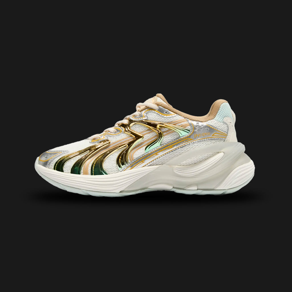 Puma Inverse Shimmer women's sneakers in Warm White and Archive Gold (402972_01). Features a layered Y2K tech-runner silhouette with a breathable Warm White mesh and synthetic leather upper. Includes highly reflective Archive Gold metallic accents, a chunky sculpted midsole for modern elevated styling, and a durable rubber outsole. Luxuntique guarantees 100% authentic Puma footwear in Sri Lanka.