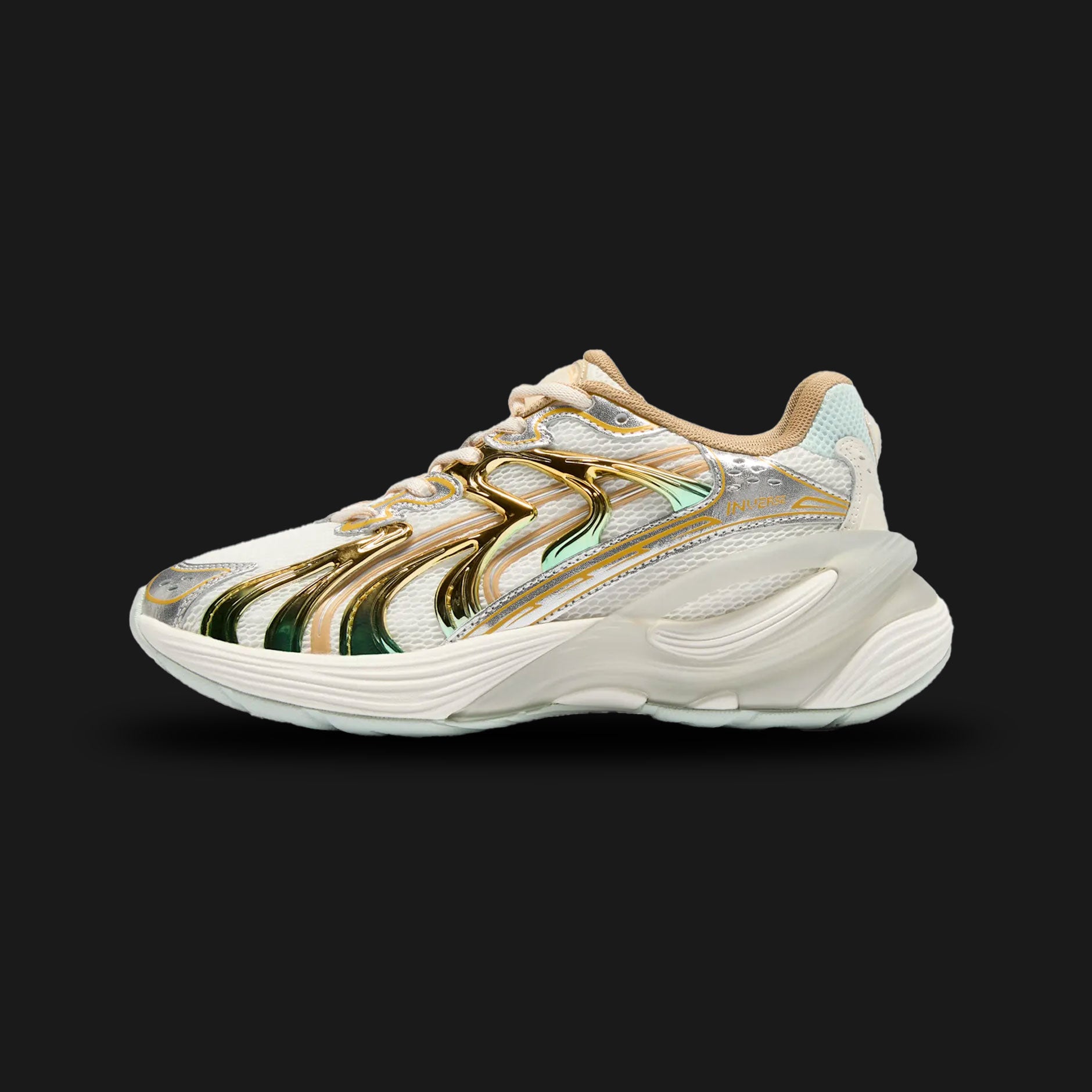 Puma Inverse Shimmer women's sneakers in Warm White and Archive Gold (402972_01). Features a layered Y2K tech-runner silhouette with a breathable Warm White mesh and synthetic leather upper. Includes highly reflective Archive Gold metallic accents, a chunky sculpted midsole for modern elevated styling, and a durable rubber outsole. Luxuntique guarantees 100% authentic Puma footwear in Sri Lanka.