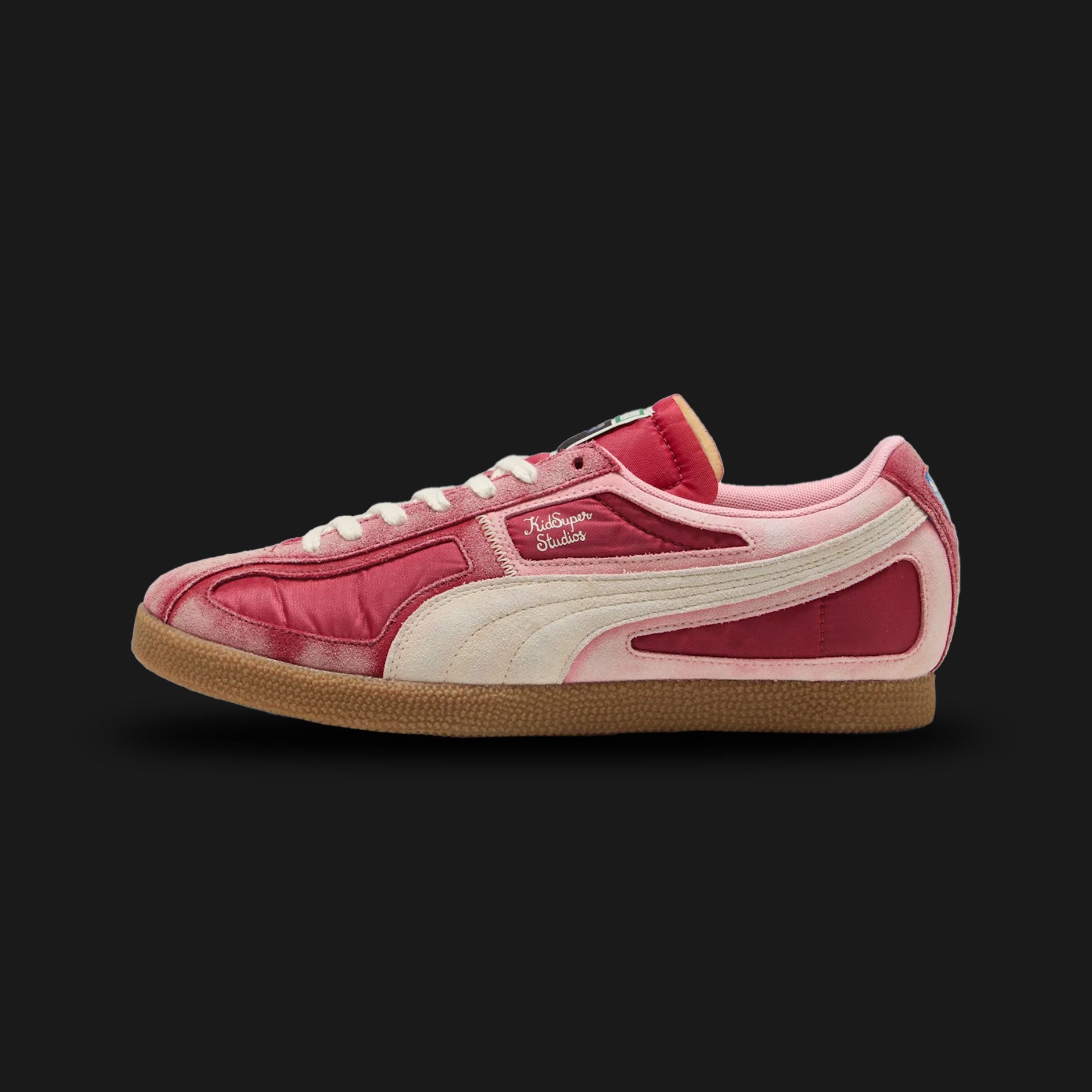 Puma x KidSuper Brasil Panels unisex sneakers in Dark Crimson and Alpine Snow (403847_01). Features a classic retro football-inspired silhouette reimagined with KidSuper's signature artistic paneling, combining premium Dark Crimson suede and Alpine Snow leather. Includes co-branded details, distinctive stitched aesthetics, and a durable retro rubber outsole. Luxuntique guarantees 100% authentic Puma footwear in Sri Lanka.