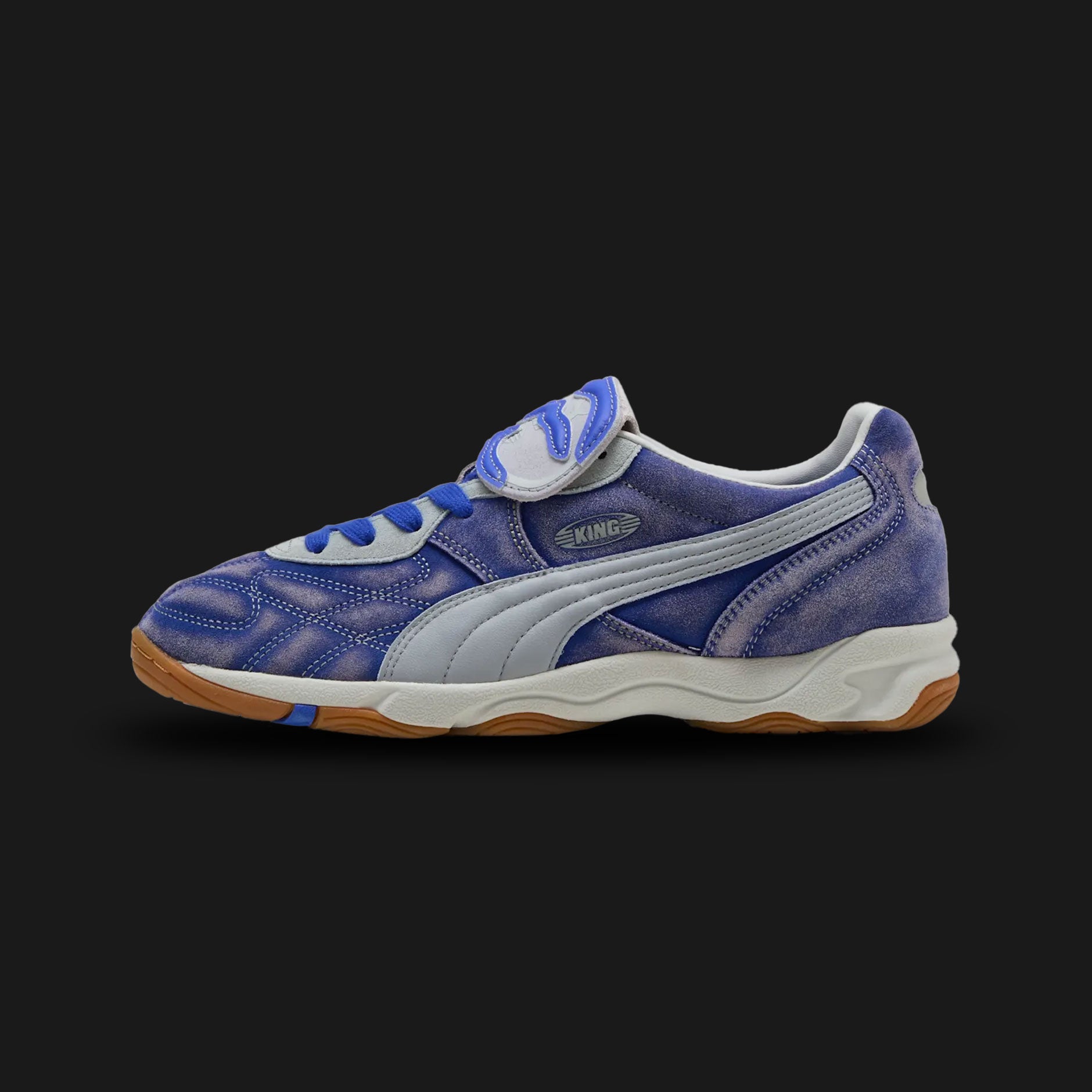 Puma x KidSuper King Indoor unisex sneakers in Dart Blue and Gray Fog (401180_01). Features a collaborative, art-inspired design reimagining the classic King silhouette with vibrant color-blocking and signature KidSuper aesthetic details. Constructed with a premium upper for comfort, co-branded detailing, and a flat rubber outsole for optimal indoor performance and high-fashion street style. Luxuntique guarantees 100% authentic Puma footwear in Sri Lanka.