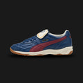 Puma King Indoor unisex sneakers in Persian Blue and Team Regal Red (401683_10). Features a classic low-profile terrace silhouette inspired by vintage football heritage, showcasing a vibrant Persian Blue upper with a contrasting Team Regal Red formstrip. Includes a durable material construction with stitched toe detailing and a flat gum-style rubber outsole designed for indoor traction and premium street style. Luxuntique guarantees 100% authentic Puma footwear in Sri Lanka.