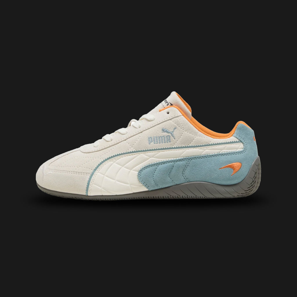PUMA McLaren Racing Speedcat Unisex sneakers in Warm White and Seafoam (309452_03). Features a premium soft white leather upper with seafoam green accents and the official McLaren Racing logo on the tongue. Low-profile tire-tread rubber outsole and rounded driver's heel. Luxuntique offers 100% authentic PUMA in Sri Lanka.