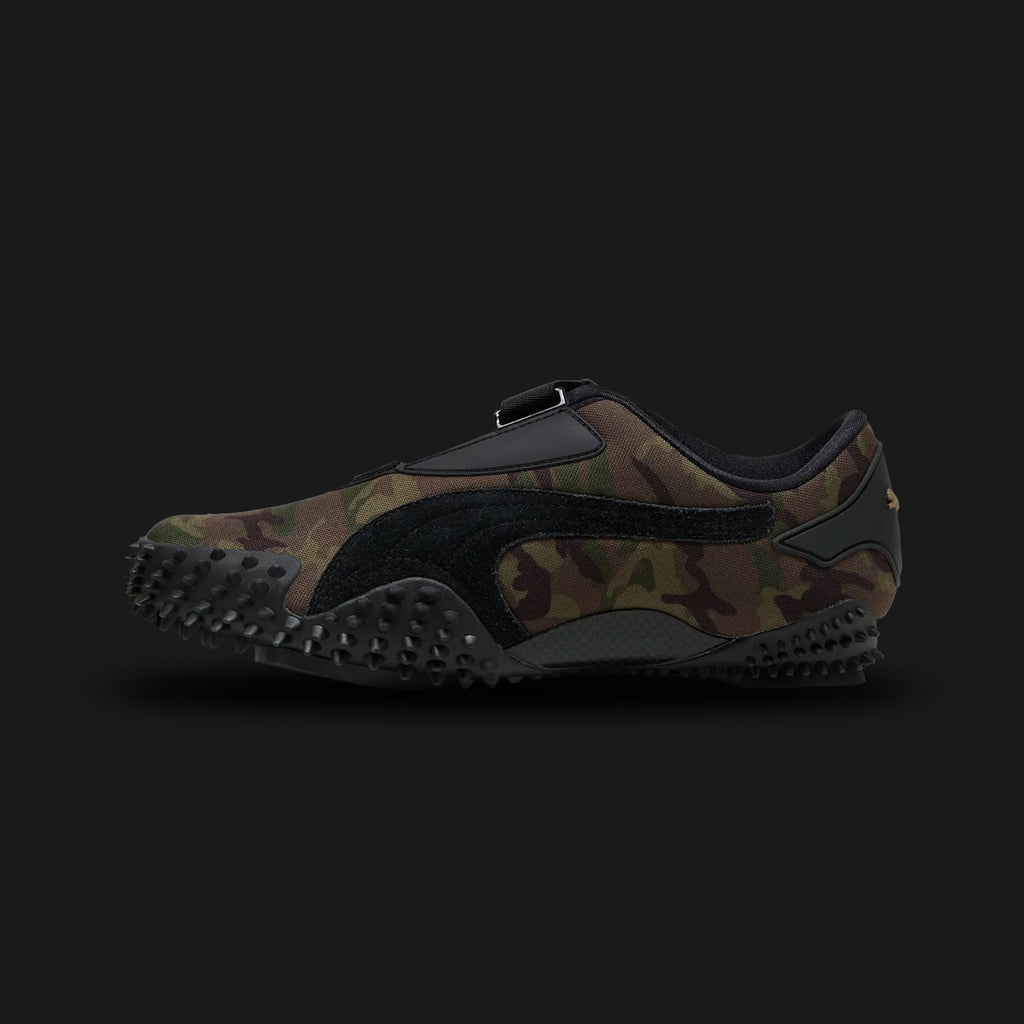 Puma Mostro Camo unisex sneakers in Wild Willow and Dark Olive (401540_03). Features the iconic low-profile, avant-garde design with a distinctive camouflage print on a premium upper. Includes the signature strap closure for a secure fit, a lightweight cushioned midsole, and a unique spike-patterned rubber outsole for exceptional grip and retro-futuristic street style. Luxuntique guarantees 100% authentic Puma footwear in Sri Lanka.