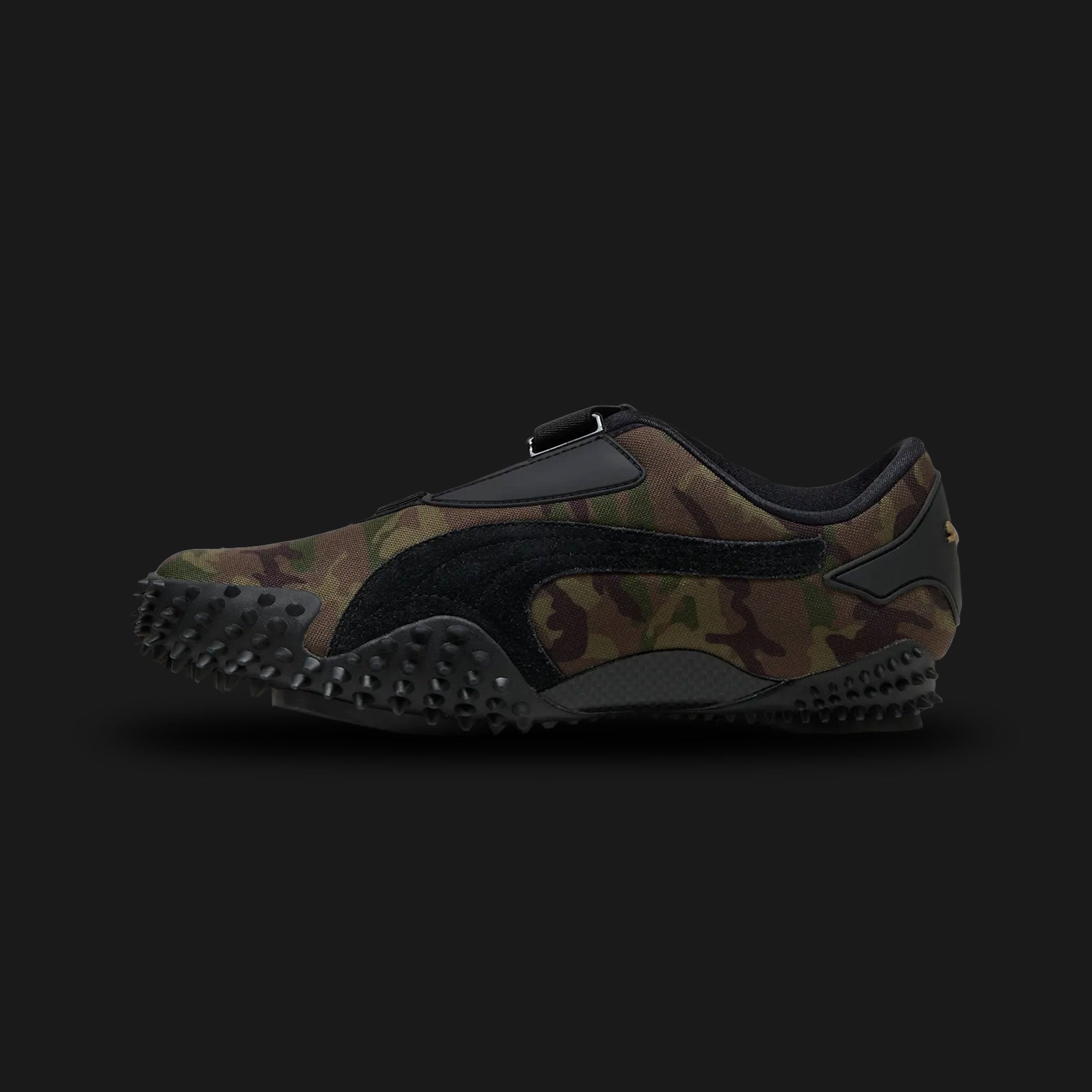 Puma Mostro Camo unisex sneakers in Wild Willow and Dark Olive (401540_03). Features the iconic low-profile, avant-garde design with a distinctive camouflage print on a premium upper. Includes the signature strap closure for a secure fit, a lightweight cushioned midsole, and a unique spike-patterned rubber outsole for exceptional grip and retro-futuristic street style. Luxuntique guarantees 100% authentic Puma footwear in Sri Lanka.