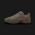 Puma Mostro X Dots unisex sneakers in Totally Taupe and Matte Bronze (406198_06). Features a hybrid avant-garde silhouette with a double-layer mesh base and a bold Matte Bronze PUMA Formstrip. Includes distinctive sculptural design, low-profile shape, and the iconic spiked rubber sole. Luxuntique guarantees 100% authentic Puma footwear in Sri Lanka.