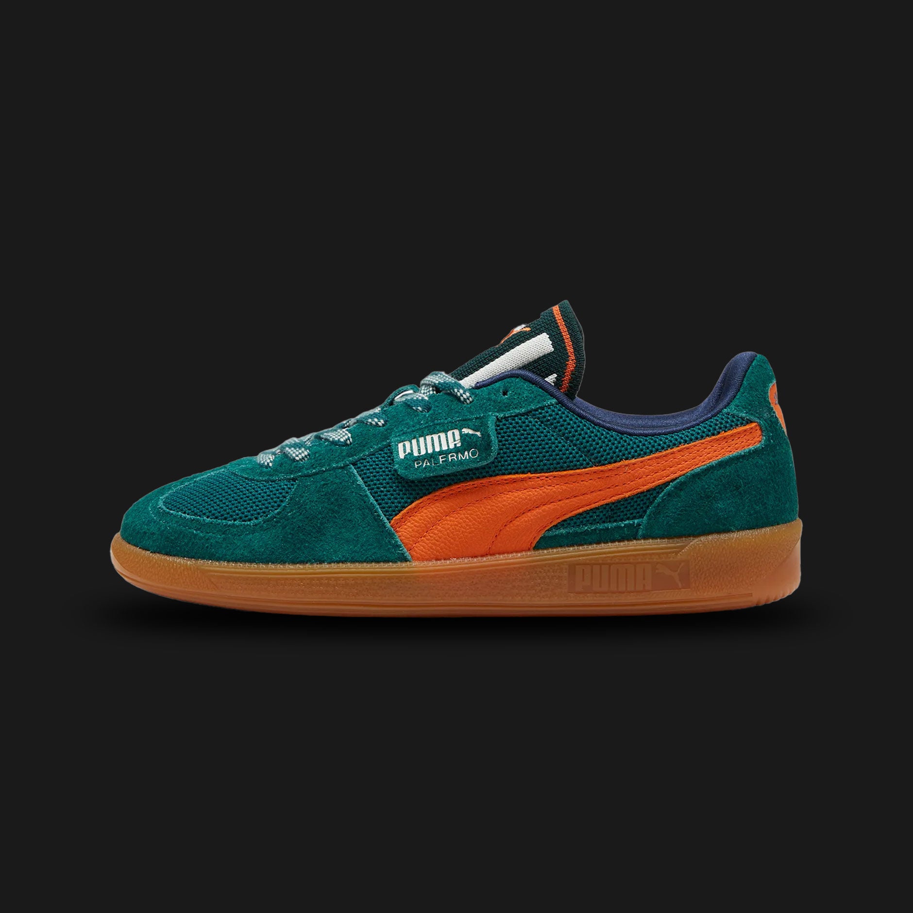 PUMA Palermo Supertifo Unisex sneakers in Dark Myrtle and Maple Syrup (398182_02). Features a premium forest green suede upper with warm maple brown leather accents and iconic T-toe construction. Gold foil Palermo branding on the lateral flap. Signature gum rubber outsole for an archival terrace look. Luxuntique offers 100% authentic PUMA in Sri Lanka.