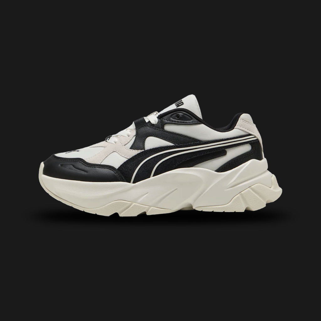 Puma Sophyr Quiet Lux women's sneakers in Vapor Gray and Puma Black (401314_01). Features a refined, chunky platform dad-shoe silhouette with a breathable textile upper and premium Vapor Gray overlays. Includes a bold Puma Black formstrip, a thick elevated EVA cushioned midsole for height and comfort, and a durable rubber outsole. Luxuntique guarantees 100% authentic Puma footwear in Sri Lanka.