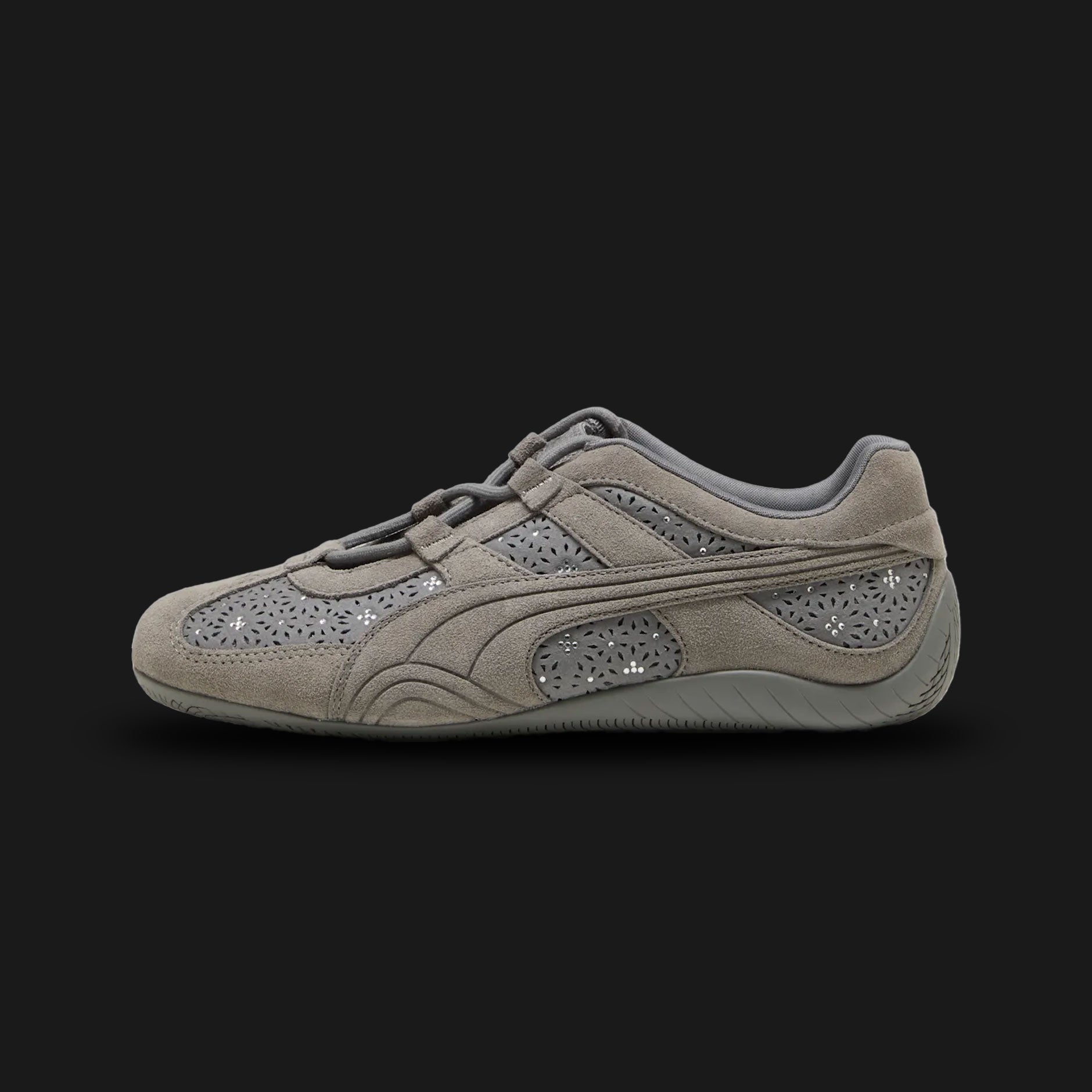 Puma Speedcat Go Bejewelled women's sneakers in dark Cast Iron grey (404906_01). Features a classic low-profile motorsport silhouette with a premium Cast Iron upper, adorned with sparkling jewelled embellishments for a glamorous touch. Includes the iconic rounded driver's heel and a durable rubber traction outsole. Luxuntique guarantees 100% authentic Puma footwear in Sri Lanka.