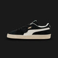 PUMA Suede Charles F. Stead I Unisex sneakers in PUMA Black and PUMA White (403700_01). Features ultra-premium British suede from the Charles F. Stead tannery with a rich, heavy nap. Deep black upper with a crisp white leather Formstrip and metallic gold foil PUMA branding. Finished with a textured white rubber midsole. Luxuntique offers 100% authentic premium PUMA in Sri Lanka.