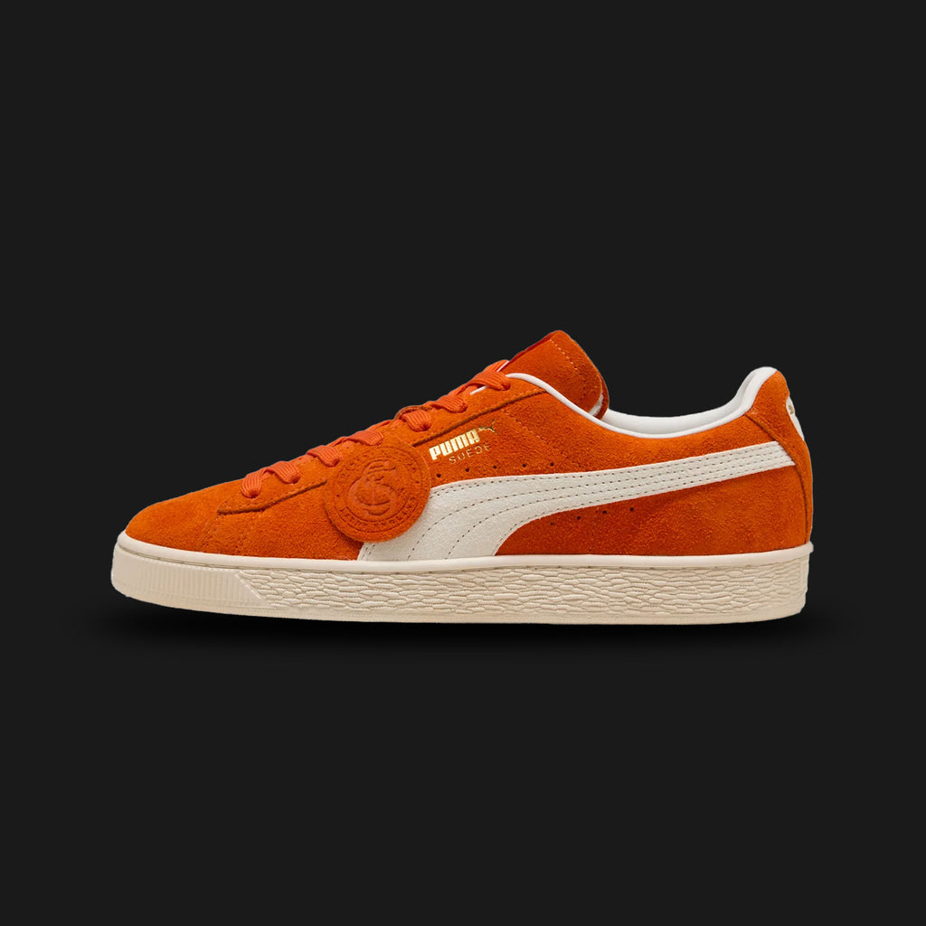 PUMA Suede Charles F. Stead I Unisex sneakers in Orange Glo and PUMA White (403766_02). Features ultra-premium, heavy-nap British suede from the legendary Charles F. Stead tannery. Vibrant orange upper with a crisp white leather Formstrip and metallic gold foil PUMA branding. Finished with a textured white rubber midsole. Luxuntique offers 100% authentic premium PUMA in Sri Lanka.