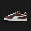 PUMA Suede Classic Unisex sneakers in Chocolate Brown and PUMA White (399781_34). Features a premium dark brown suede upper with a crisp white leather Formstrip and metallic gold foil PUMA branding. Finished with the signature textured white rubber outsole. A 1968 archival icon. Luxuntique offers 100% authentic PUMA in Sri Lanka.