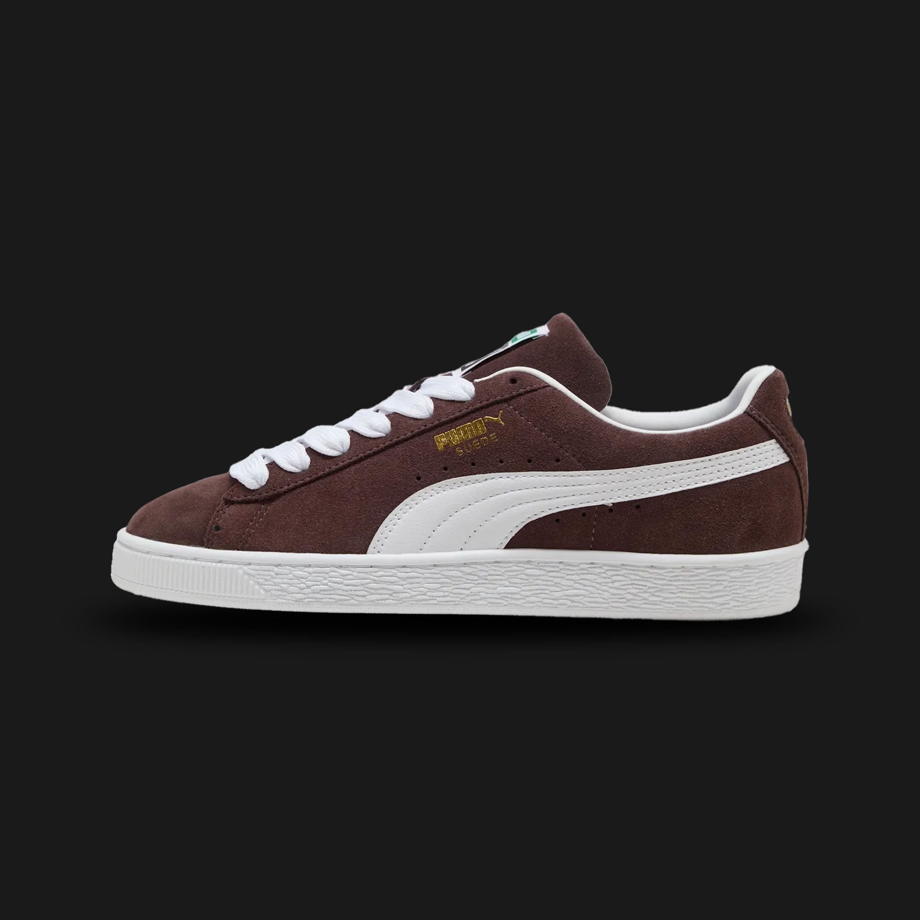 PUMA Suede Classic Unisex sneakers in Chocolate Brown and PUMA White (399781_34). Features a premium dark brown suede upper with a crisp white leather Formstrip and metallic gold foil PUMA branding. Finished with the signature textured white rubber outsole. A 1968 archival icon. Luxuntique offers 100% authentic PUMA in Sri Lanka.