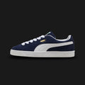 PUMA Suede Classic Unisex sneakers in PUMA Navy and PUMA White (399781_03). Features a premium deep navy suede upper with a crisp white leather Formstrip and metallic gold foil PUMA branding. Finished with the signature textured white rubber outsole. A 1968 archival icon. Luxuntique offers 100% authentic PUMA in Sri Lanka.