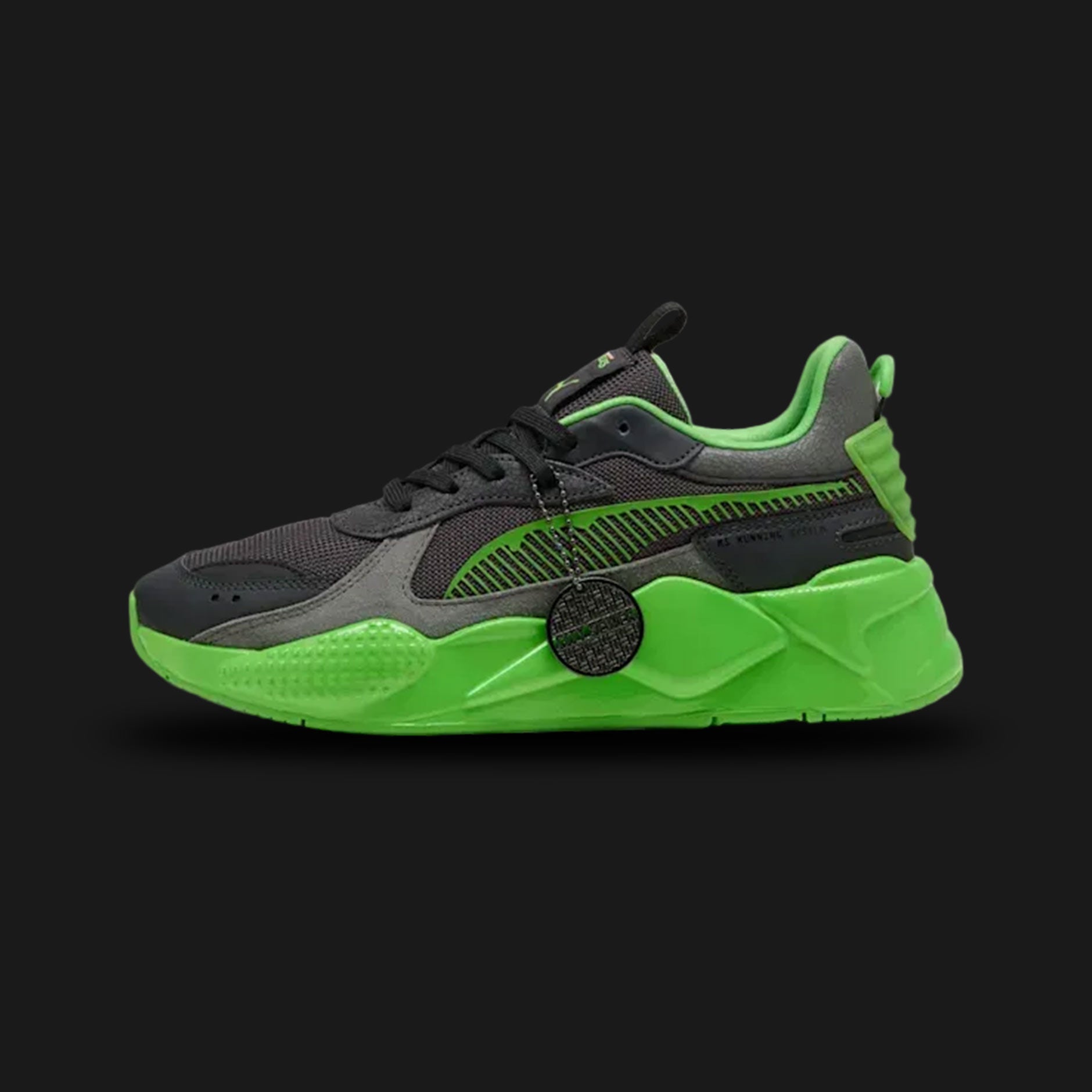 PUMA x TMNT RS-X limited edition sneakers in PUMA Black and Leafy Green (Design Code: 402373-01). Featuring a bulky RS silhouette with turtle-shell textures, red accents representing Raphael, and a custom TMNT lace charm. Luxuntique offers 100% authentic PUMA collaboration sneakers at the lowest price in Sri Lanka.