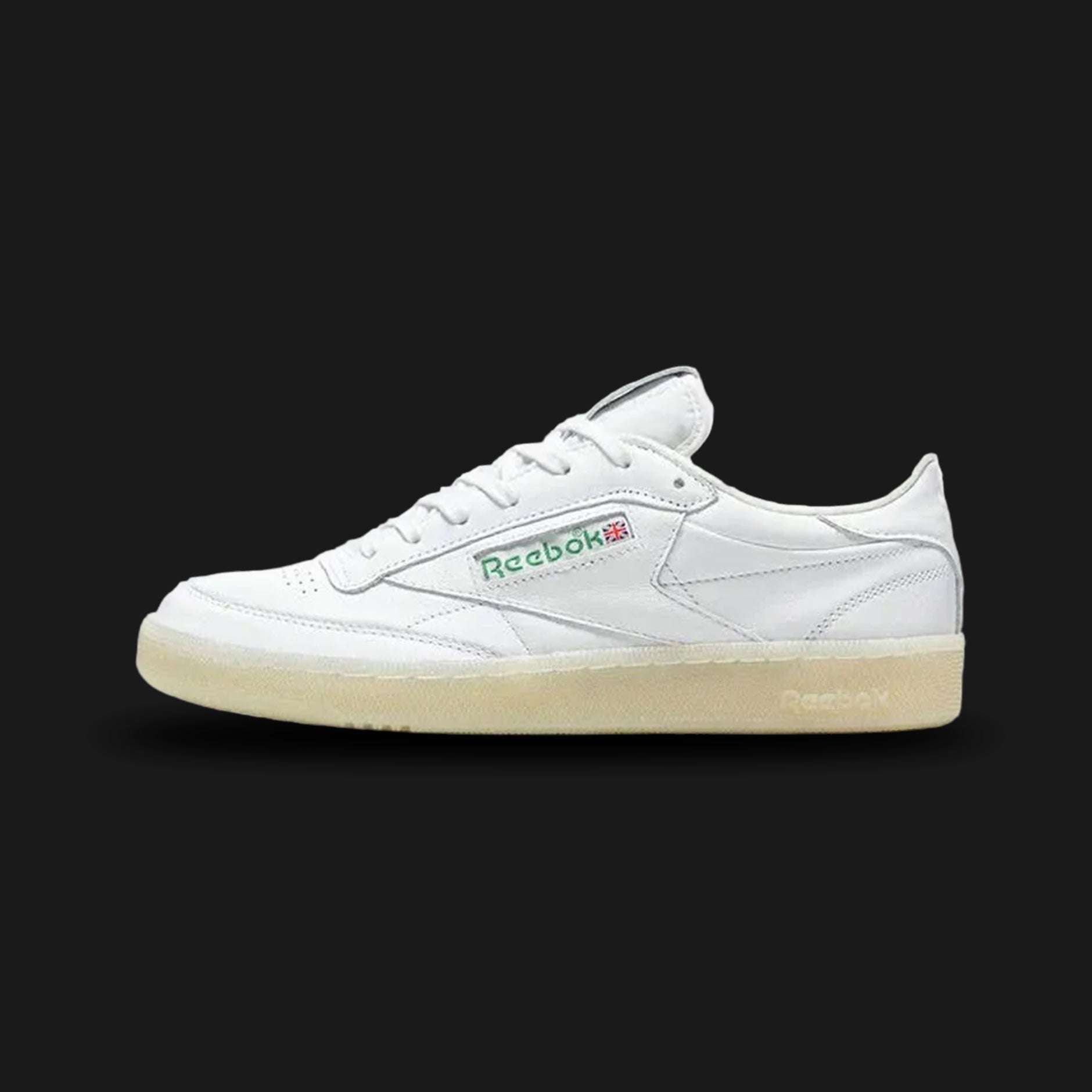 Reebok Club C 85 Vintage shoes in Chalk, Paper White, and Glen Green (Design Code: 100209029). Featuring a premium garment leather upper with an aged vintage aesthetic, soft terry cloth lining, and the iconic Union Jack logo window. Includes a comfortable EVA midsole and a durable rubber outsole. Luxuntique offers 100% authentic Reebok heritage sneakers at the lowest price in Sri Lanka.