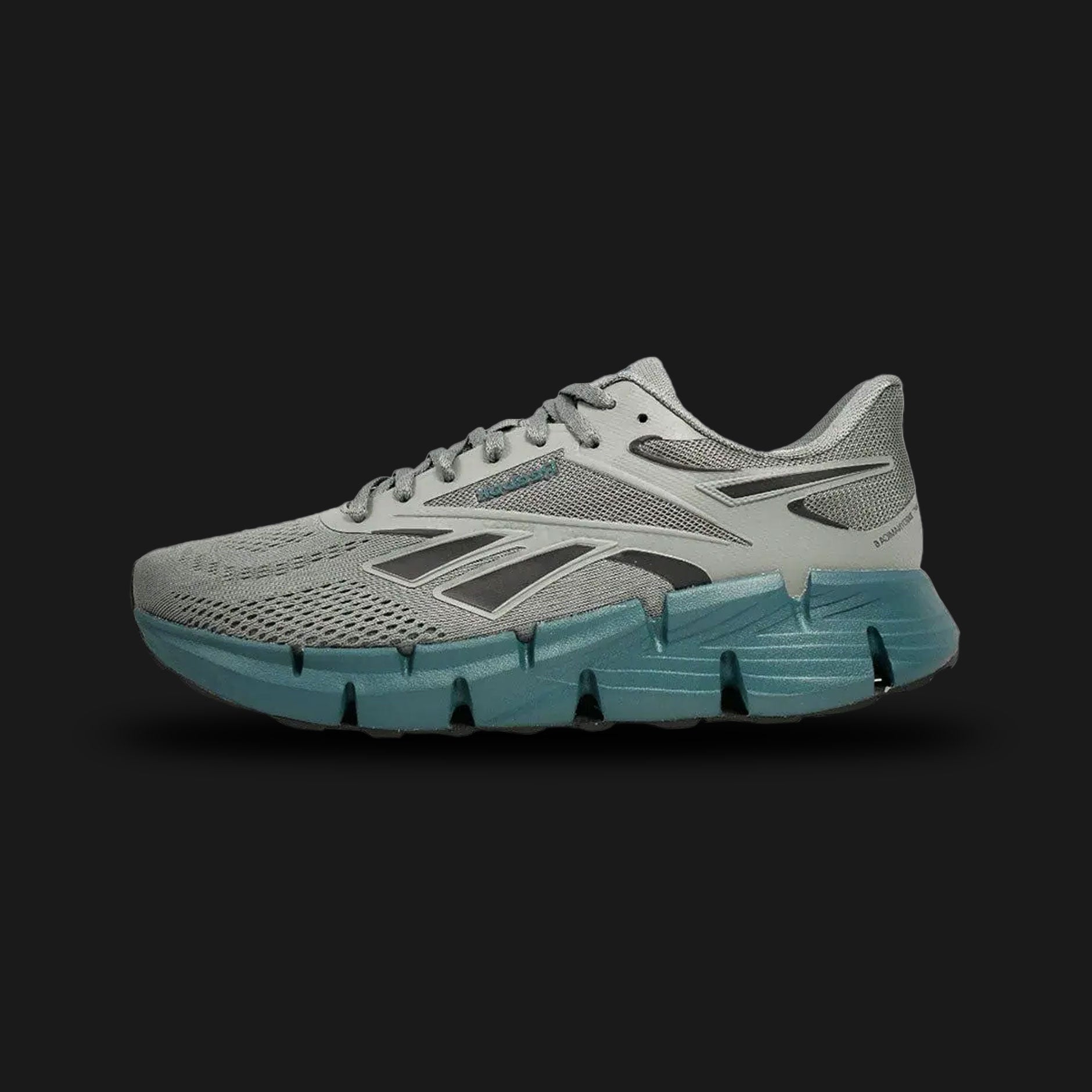 Reebok Zig Dynamica 6 men's shoes in Dark Fog, Retro Teal, and Yellow Haze (100225488). Features a lightweight, breathable mesh upper for daily comfort and the signature zigzag-shaped energy-returning midsole for responsive cushioning. Includes a durable rubber outsole for reliable grip and striking retro-inspired color accents. Luxuntique guarantees 100% authentic Reebok footwear in Sri Lanka.